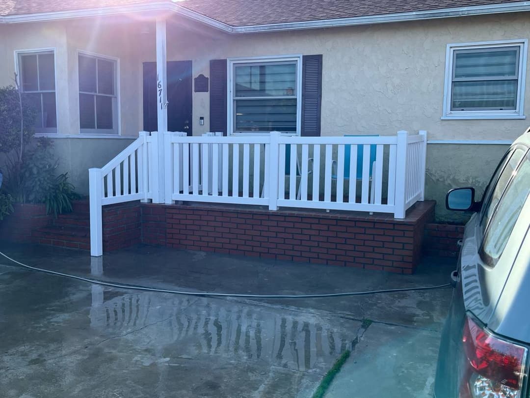 white vinyl fence surrounding a front patio and deck