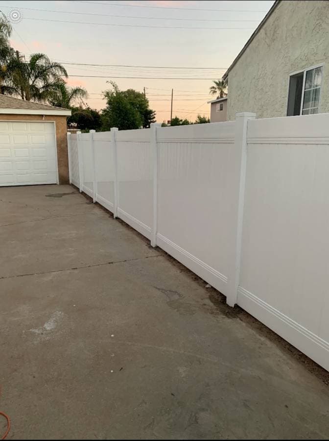 white vinyl fence surrounding the side of a home