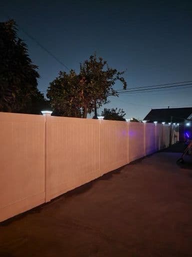 picture of white vinyl fence with glow in the dark caps